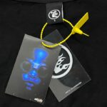 Close-up of the Hellstar Inner Peace T-Shirt brand tag featuring a vibrant graphic, product labels, and yellow cord.