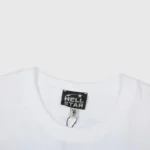 Close-up view of the interior neck label and branding on a premium white Hellstar Inner Peace cotton graphic t-shirt.