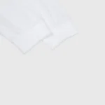 Close-up view of the sleeve detail on the premium white long sleeve cotton Hellstar Inner Peace graphic t-shirt.
