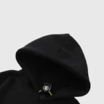 Close-up view of the black Hellstar Jason Mask Hoodie showing the premium fleece fabric and branded neck label detail.