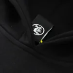 Close-up view of the branded neck label detail on the black Hellstar Jesus Freak graphic streetwear hoodie.
