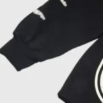 Close-up detail view showing the fabric sleeve and graphic print of the black Hellstar Jesus streetwear sweatshirt.