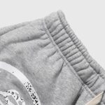 Close-up view of the elastic waistband on Hellstar Jupitar Graphic Terry Grey streetwear shorts in heather grey.
