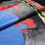 Detailed close-up view of the Hellstar Knock Out T-Shirt featuring bold red, blue, and black graphic print design.
