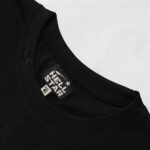 Close up view of the inner neck label on a black Hellstar Knock Out t-shirt showing branding and fabric detail.