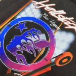 Detailed close-up of the Hellstar Las Vegas T-shirt graphic featuring vibrant flame and star motifs on black cotton.