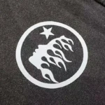 Close-up of the Hellstar Las Vegas T-shirt graphic featuring a white star and abstract flame design on black cotton.