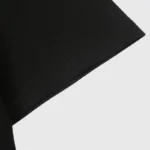 Close-up view of the sleeve detail on a premium black cotton Hellstar Lens of Honesty graphic t-shirt for streetwear.
