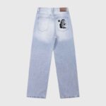 Back view of light wash Hellstar denim jeans featuring a black flame graphic detail on the back pocket.