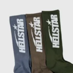 A 3-pack of premium Hellstar logo socks in earthy tones featuring comfortable cotton construction and bold branding.