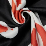 Close-up view of the orange, black, and white mesh fabric texture from the Hellstar Logo URL long sleeve tee.