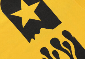 Close-up of the black graphic screen print on the yellow Hellstar Marathon vintage washed cotton unisex t-shirt.