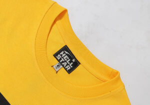 Hellstar Marathon T-Shirt in vibrant yellow featuring a detailed branded neck tag and premium 100% cotton fabric.