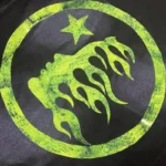 Hellstar Marble Classic T-Shirt black fabric featuring a circular neon green flame graphic with a top star detail.