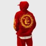 Back view of a person wearing a red Hellstar mask print hoodie featuring a bold golden circular graphic.