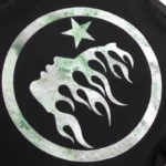Hellstar Mirror Face graphic print featuring a stylized flame-like face silhouette and star inside a circular emblem.