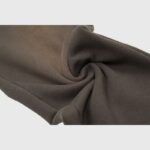 Close up of the premium brown fabric texture used in the Hellstar Mirror Faced sweatpants design for streetwear