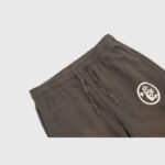 Close-up of the Hellstar Mirror Faced sweatpants in brown, featuring an elastic drawstring waistband and graphic logo.