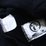 Hellstar Motion Blur Tracksuit interior label showing 100% cotton fabric and official brand authenticity tag.