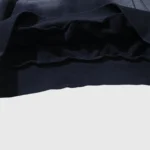 Detailed view of the ribbed hem and soft cotton fabric on a black Hellstar Motion Blur tracksuit hoodie.