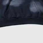 Close-up view of the front pocket and ribbed hem detail on the black Hellstar Motion Blur Tracksuit hoodie garment.