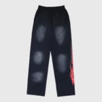 Black Hellstar Motion Blur tracksuit pants featuring a distinctive distressed wash and dynamic red graphic print detailing.