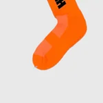 Bright orange Hellstar logo socks from a 4-pack featuring vibrant neon colors and signature streetwear branding.