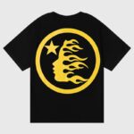 Hellstar No Guts No Glory black tee with bold yellow circular back logo featuring a flaming face profile and star