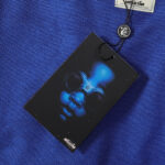 Hellstar No Guts No Glory Blue Hoodie authentication hangtag with iconic brand logo against blue fabric background.