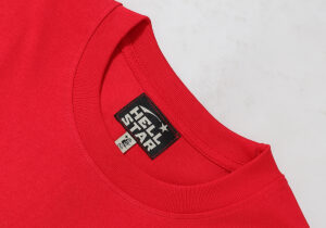 Close-up view of the interior neck brand label on a red Hellstar No Guts No Glory vintage style cotton T-shirt.