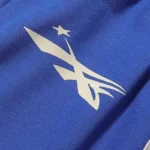 Close-up view of the white graphic print on royal blue fleece fabric from Hellstar No Guts No Glory streetwear shorts.