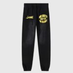 Black Hellstar No Guts No Glory sweatpants featuring yellow screen-printed graphics and fleece fabric.