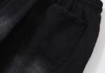 Detailed view of the rear pocket on the black Hellstar No Guts No Glory sweatpants featuring premium fabric texture