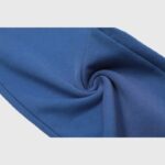 Detail shot showing the soft, vintage washed blue fleece fabric of Hellstar No Guts No Glory sweatpants.