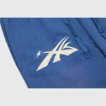 Close-up of the Hellstar No Guts No Glory sweatpants in blue showing the white logo graphic and drawstring detail.