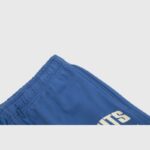 Close-up view of the adjustable drawstring waistband on the Hellstar No Guts No Glory blue fleece sweatpants.