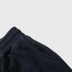 Close-up view of the side pocket and elastic waistband detail on the black Hellstar No Humanity streetwear shorts.