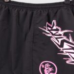 Black Hellstar nylon athletic shorts featuring a bold pink graphic design and an elastic drawstring waistband.