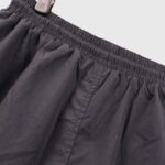 Detail of the black elastic waistband featured on the Hellstar Nylon Athletic Shorts street style apparel.