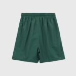 Pair of green Hellstar nylon athletic shorts featuring an elastic waistband and relaxed fit for street style.