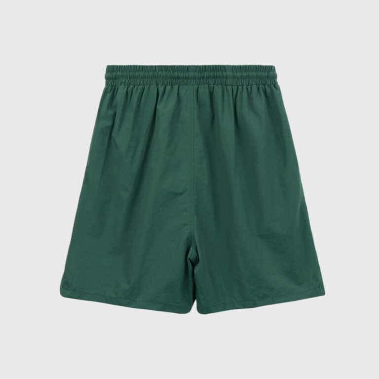 Pair of green Hellstar nylon athletic shorts featuring an elastic waistband and relaxed fit for street style.