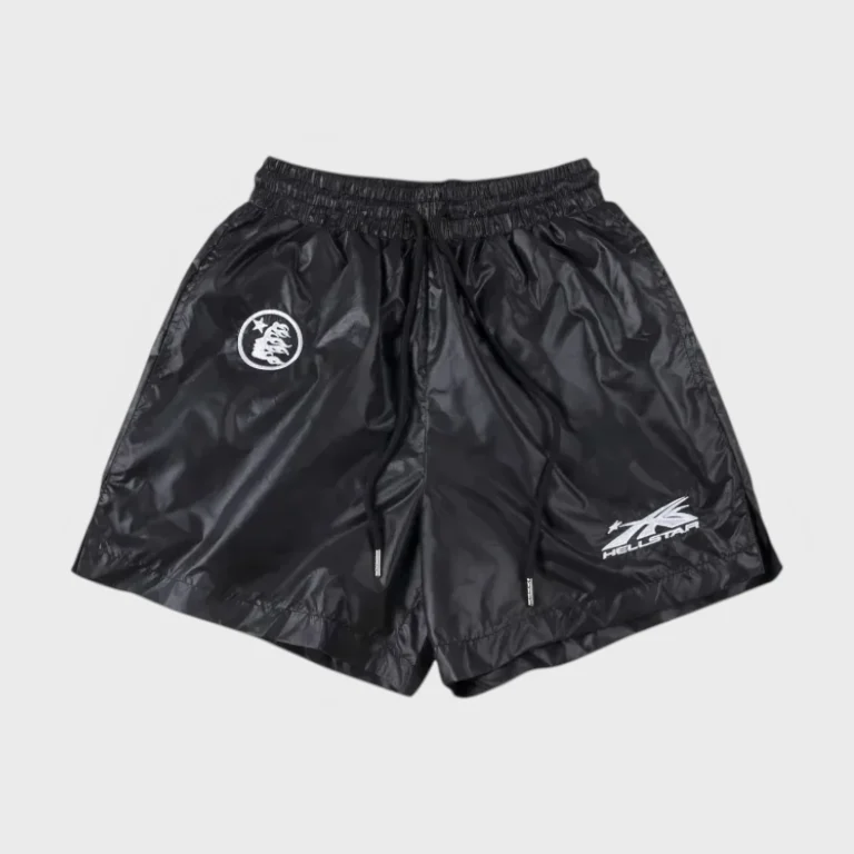 Front view of black Hellstar nylon shorts with a drawstring waist and branded logo detailing on a grey background.