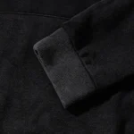 Close-up view of the premium heavyweight fleece fabric and ribbed cuff on the black Hellstar OHM streetwear hoodie.