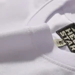 Close-up view of the white Hellstar P2P T-shirt neck label and premium cotton fabric texture detailing for quality.