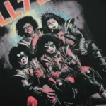 Close-up of the vintage-style graphic on the black Hellstar Paradise Girls T-shirt featuring a stylized rock band.