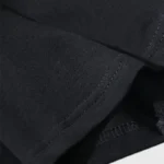 Close-up view of the premium black cotton fabric used for the Hellstar Paradise Girls T-shirt showing stitching.
