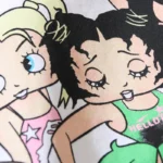 A close-up view of the cartoon-style character graphic on the Hellstar Paradise Girls cotton graphic t-shirt.
