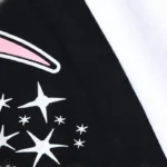 Close-up view of the Paradise graphic on the black Hellstar girls t-shirt featuring stars and a unique design element.