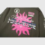 Front view of the Hellstar Path To Paradise hoodie featuring a prominent pink sun graphic and vintage streetwear branding.