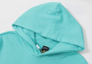 Close-up view of the hood detail on the vibrant teal Hellstar Path to Paradise hooded sweatshirt for streetwear fans.